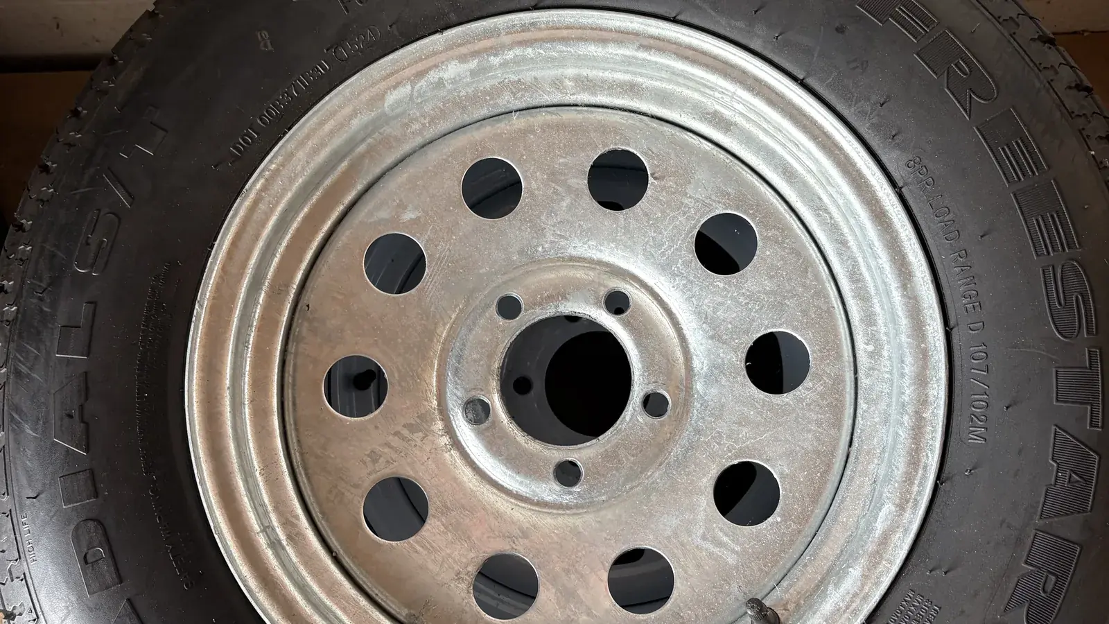 Mounted ST radial trailer tire on a galvanized mod wheel, ready to bolt on