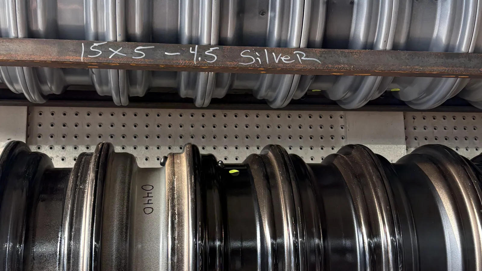 15x5 5-on-4.5 silver mod trailer wheels on the rack at Grandville Trailer